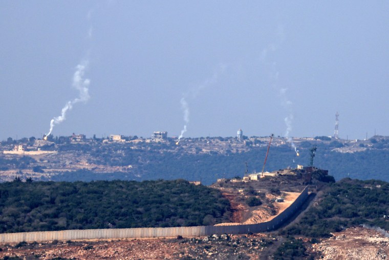 Flares are fired from northern Israel over the southern Lebanese border village of Aita al-Shaab.