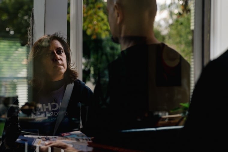 Rachna Sizemore Heizer chats with a resident as she canvasses in Fairfax, Va., on Oct. 8, 2023