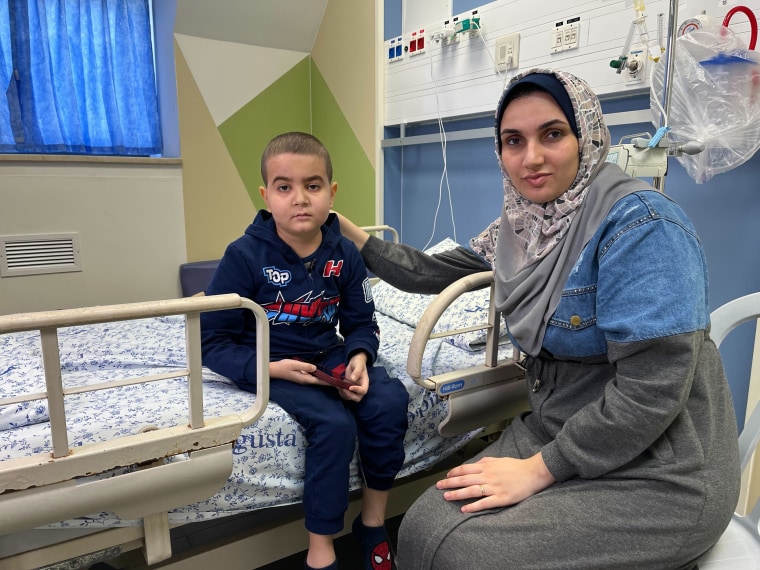 May Jalal and her son, Ali Jnaina, sit in their room at the Augusta Victoria Hospital, in East Jerusalem, where they have been trapped since the conflict started in Gaza.