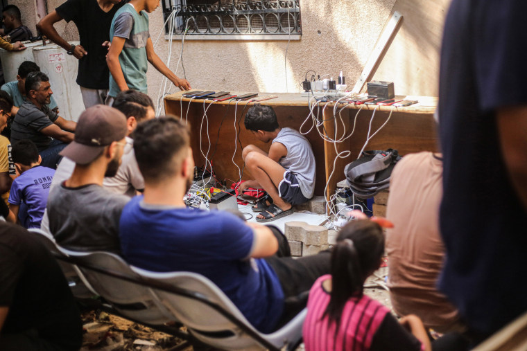 A Palestinian boy sits under the table inside the Al-Amal