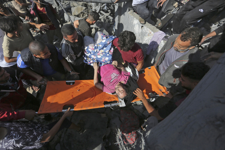Palestinians evacuate survivors of the Israeli bombardment of the Gaza Strip in Rafah on Monday, Oct. 30, 2023. 