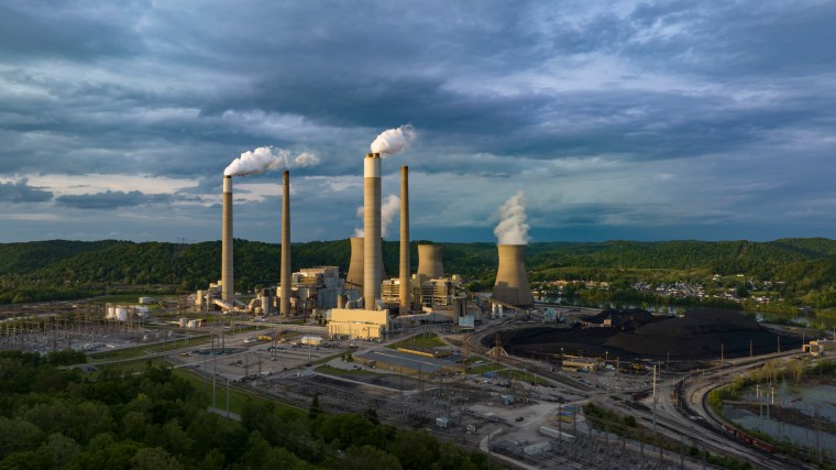 Aerial view of power plant's shows smoke stacks and cooling. 