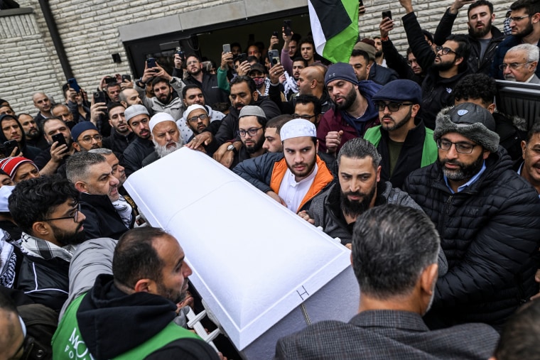 Oday Al-Fayoumi (bottom right of casket) holds the casket with the remains of his 6-year-old Palestinian American son Wadea Al-Fayoumi after a prayer service in Bridgeview, Ill. on Oct. 16, 2023.  Wadea Al-Fayoumi and his mother Hanaan Shahin were stabbed several times by their landlord Joseph Cuba as he yelled anti-Muslim statements at their home in Plainfield, Illinois.