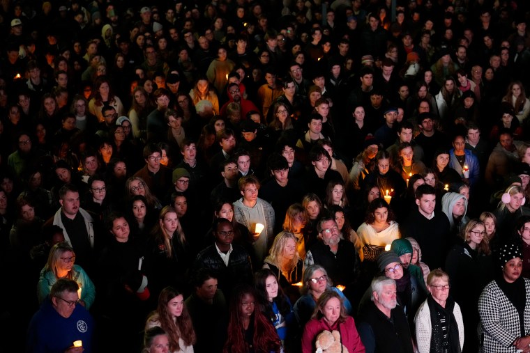 People gather at a vigil for the victims of Lewiston's mass shootings.