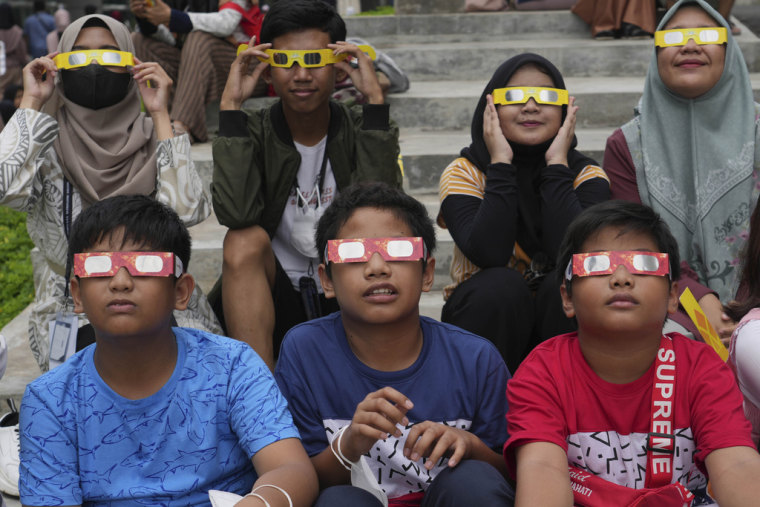 Young People Wear Protective Glasses To Watch The Solar Eclipse In Jakarta, Indonesia, Thursday, April 20, 2023. 