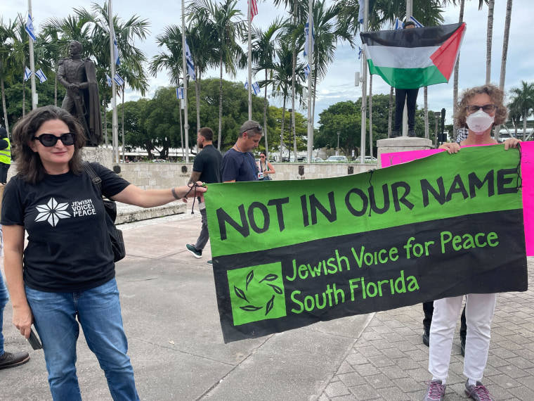 Jewish Anti-Zionist protesters from "Jewish Voice for Peace" stand with "Free Palestine" demonstrators.