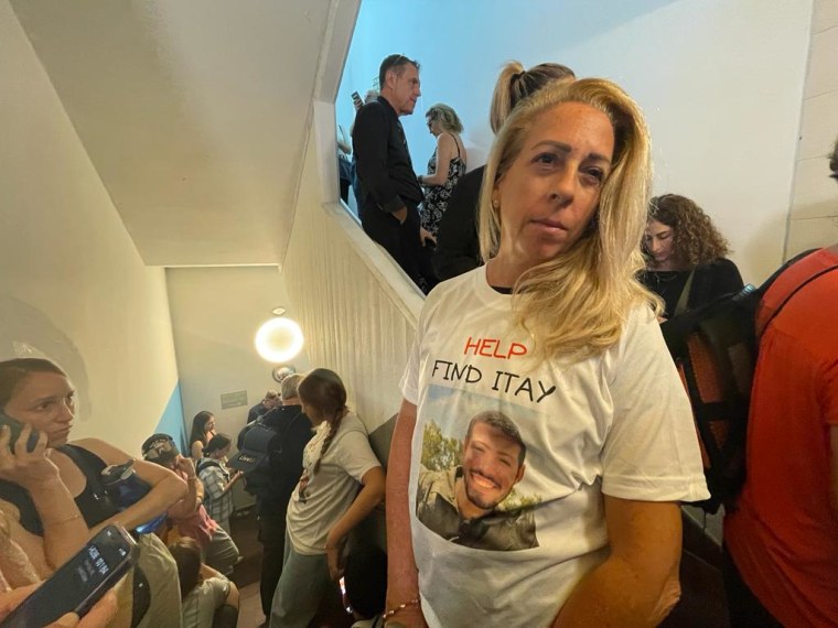 Orly Chen, 56, stands in a stairwell, taking shelter as sirens warning of a possible air attack sound in Tel Aviv on Tuesday following a news conference her family gave about her nephew, Itay Chen.