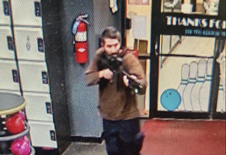 In this image taken from video released by the Androscoggin County Sheriff's Office, an unidentified gunman points a gun while entering Sparetime Recreation in Lewiston, Maine, on Oct. 25.