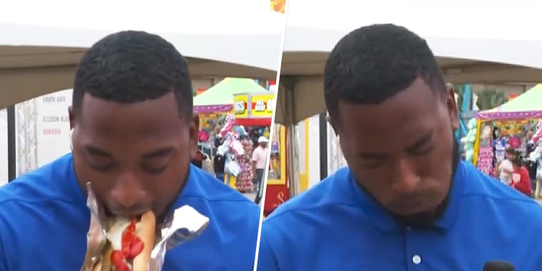 WIS reporter Jalen Tart taking a bite of a Polish hot dog, then immediately regretting it.