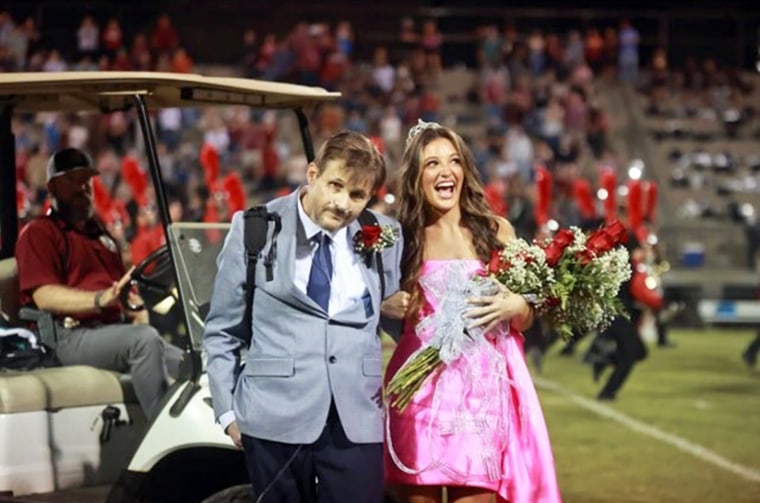 During his walk across the football field, Brett Yancey held tight to his daughter, Sara Kate, to keep steady. There wasn't a dry eye after he made the trek. 