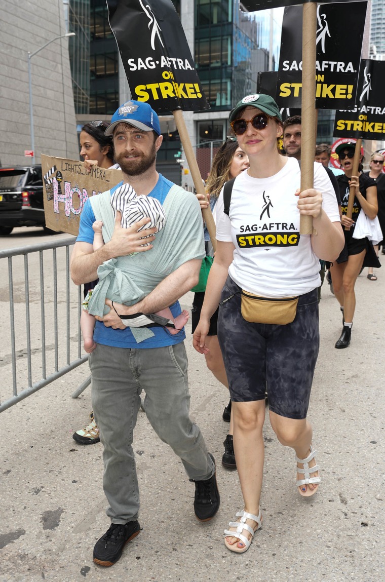 Daniel Radcliffe and Erin Darke on the picket line with their son