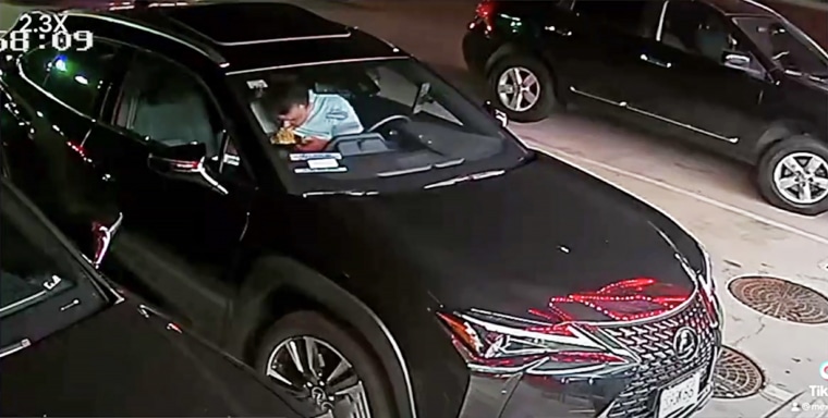 Grubhub driver eating noodles in his car.