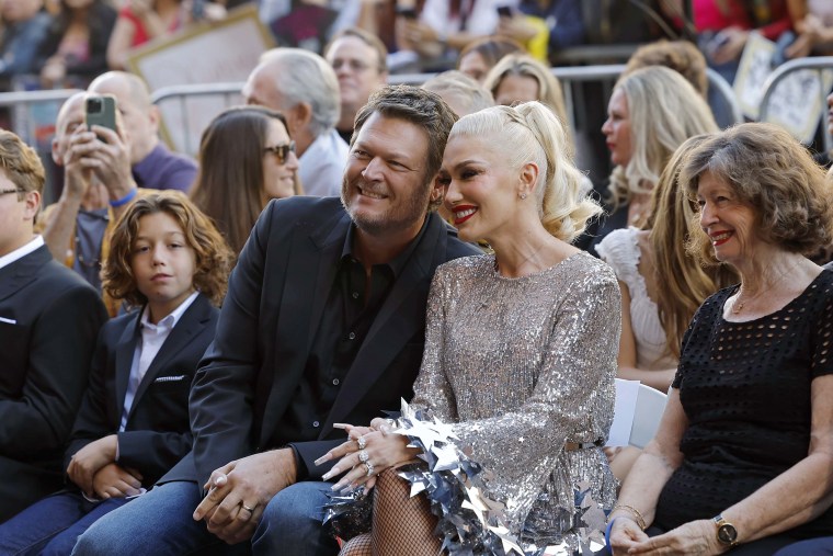 Blake Shelton sits near Gwen Stefani during her Hollywood Walk of Fame ceremony