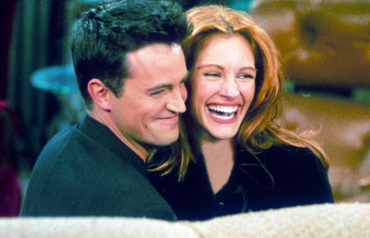 Matthew Perry and Julia Roberts hug each other on the set of "Friends."