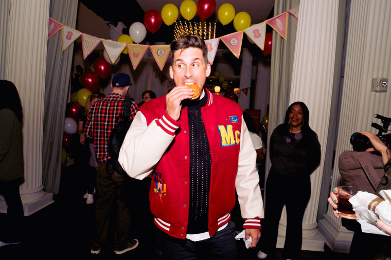 Cody Rigsby enjoys a burger at the 1 in 8 Homecoming celebration in New York City.
