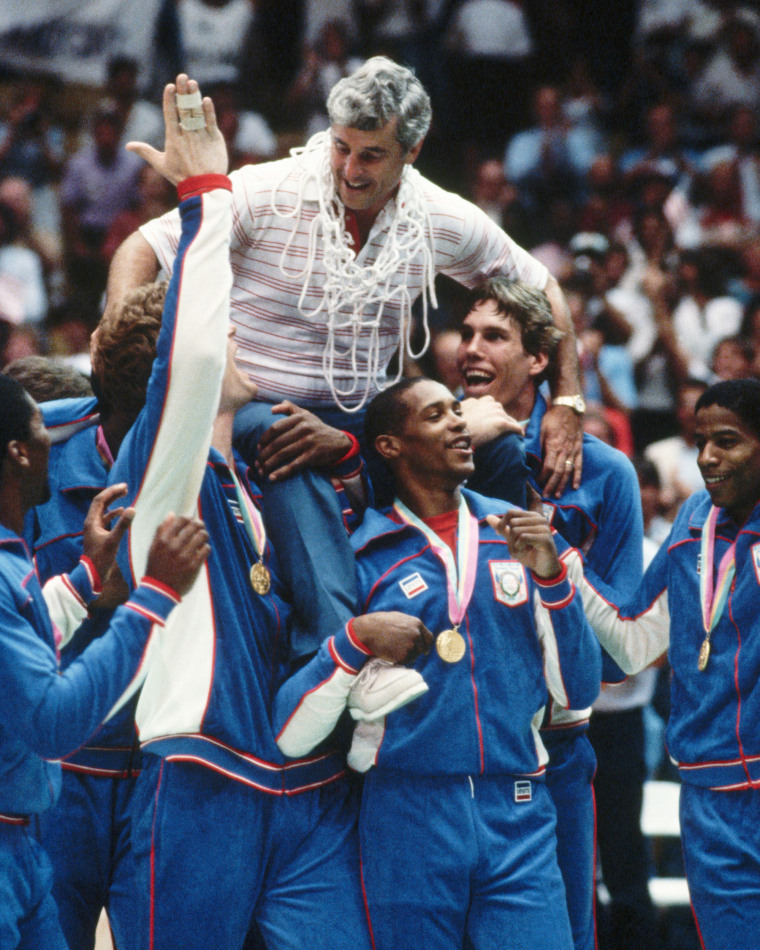The US Men's Olympic basketball team carries their coach, Bobby Knight.