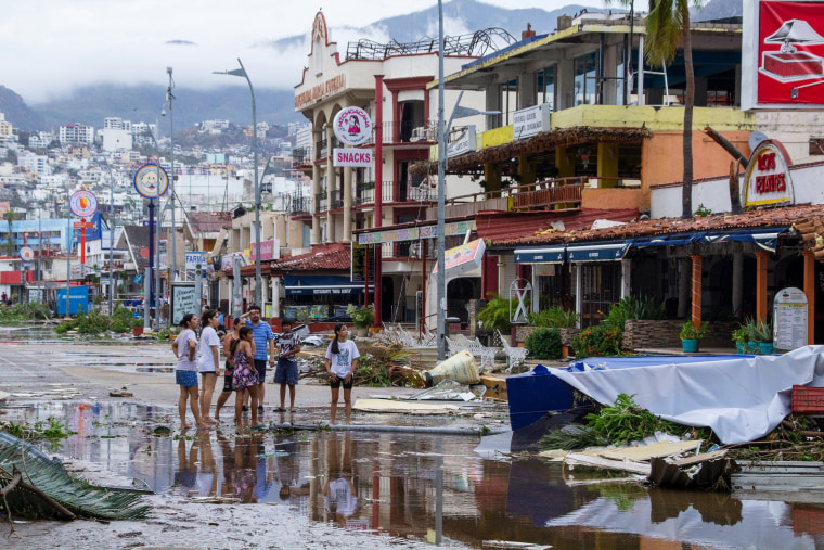 Residents look at debris in the streets after hurricane Otis hit Acapulco on Oct. 25.