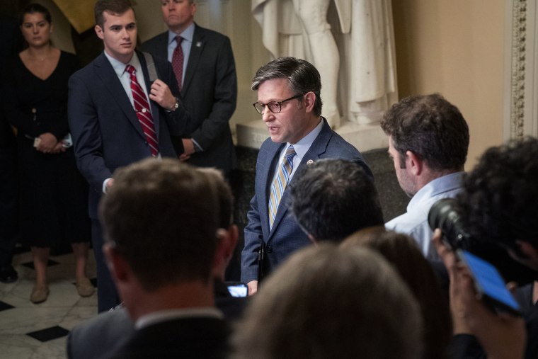 Reporters and staffers circle Rep. Mike Johnson as he speaks