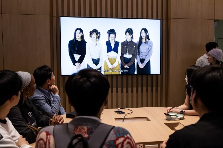 A video of K-pop girl group NewJeans on screen during the opening of an Apple Inc. store.  In Seoul, South Korea on March 31, 2023.