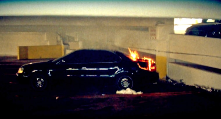 1992 Black Acura with flames scorching its trunk.