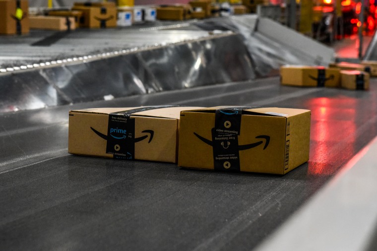 Amazon packages on a conveyor belt.