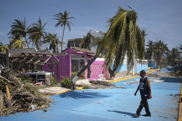 Image: A man walks past a damaged home and street in the aftermath of Hurricane Otis in Acapulco, Mexico, on Oct. 29.