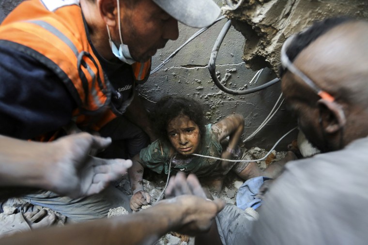 People pull a girl out of the rubble of a building that was destroyed by Israeli airstrikes in the Jabalia refugee camp in Gaza.