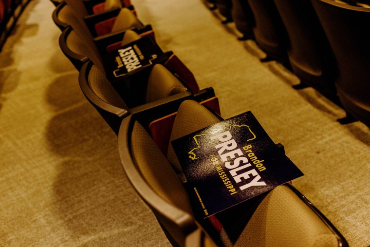 "Brandon Presley for Mississippi" signs on chairs in an auditorium.