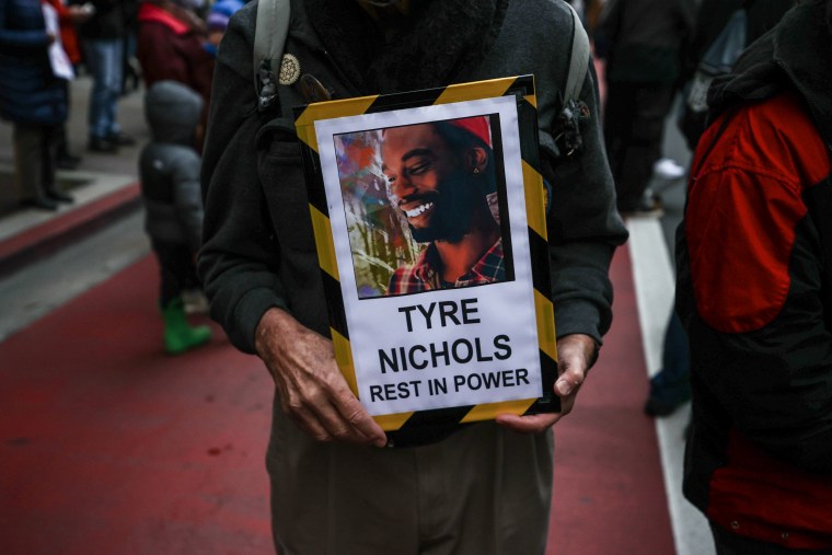 A protestor holds a sign with Tyre Nichols after he was killed by Memphis police, in Oakland, Calif. on January 29, 2023. 
