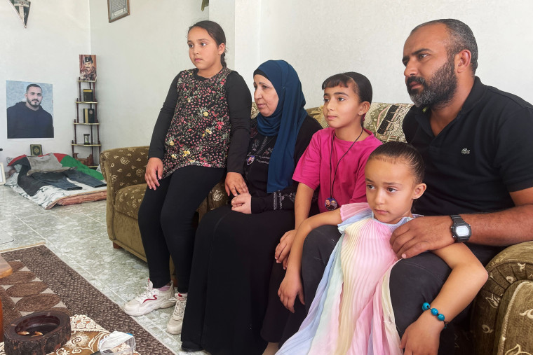 Murad Jebril, right, sits with his mother, Samiha, and his daughters, Lamar, Nouran and Selmam, at home Wednesday.