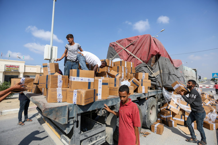 Trucks carrying aid enter through the Rafah crossing