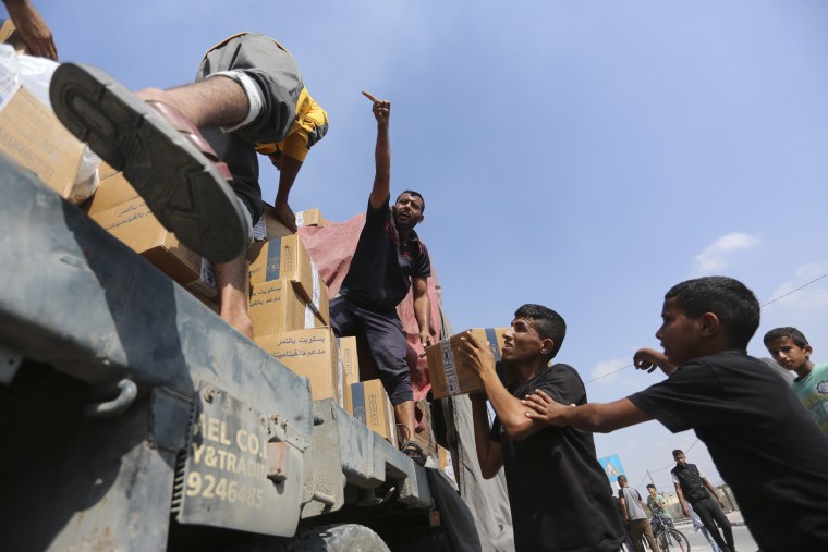 Palestinians loot a truck with humanitarian aid near the Rafah border crossing