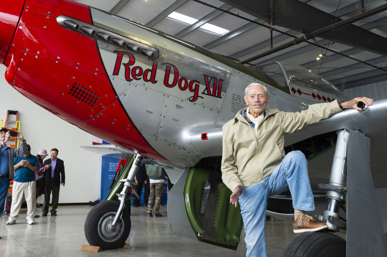 Harry Moyer in front of a P-51 Mustang fighter aircraft in Livermore, Calif.