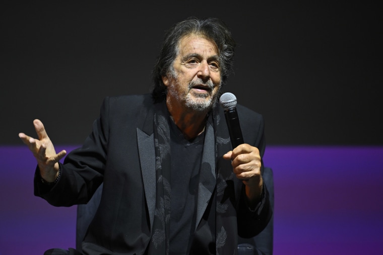 Al Pacino speaks onstage while holding a microphone