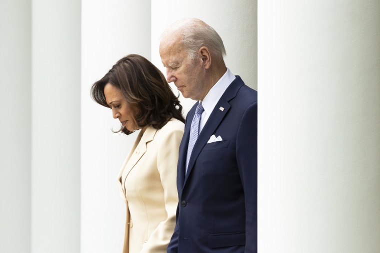 Vice President Kamala Harris and President Joe Biden walk through the white columns of the White House colonnade