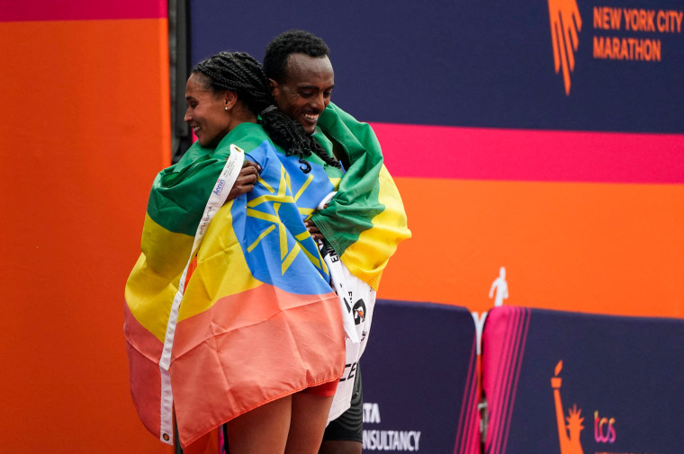 Ethiopia's Tamirat Tola and Kenya's Hellen Obiri celebrate winning the men's and women's division of the New York City Marathon.