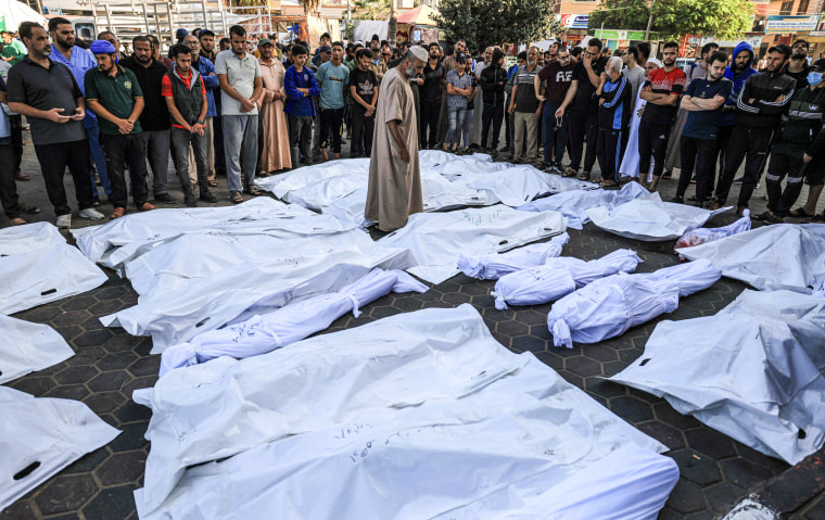 A man walks among the dead outside the Shuhada Al-Aqsa hospital in Deir al-Balah on Nov. 6, 2023.