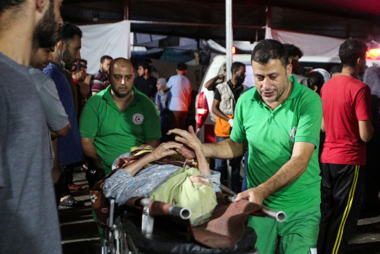 Medics transport a wounded woman to Al-Shifa hospital in Gaza City.