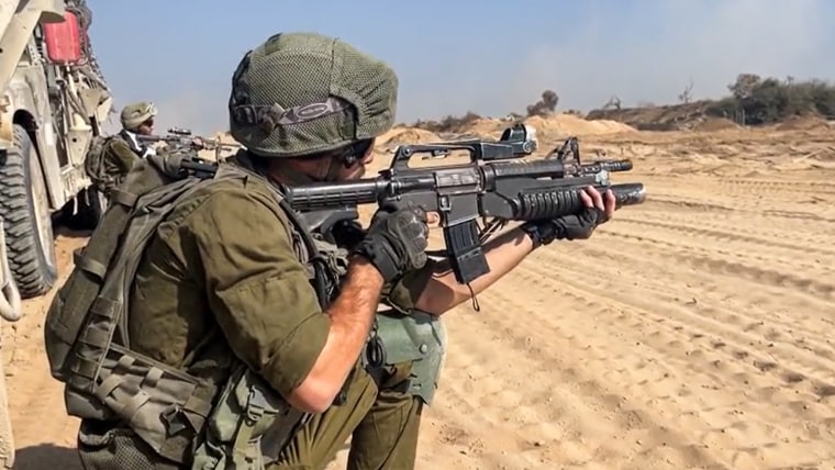 An IDF soldier points his gun in northern Gaza.