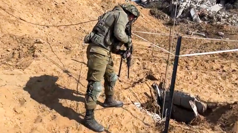 An IDF soldier looks down a tunnel allegedly used by Hamas militants in northern Gaza on a tour led by by the IDF.