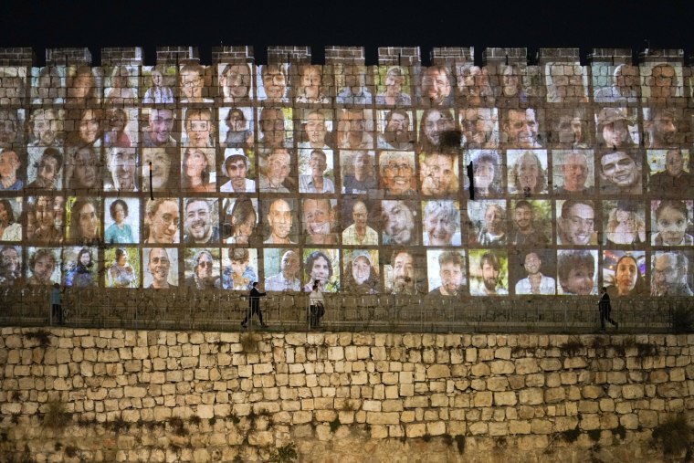 Photographs of Israeli hostages being held by Hamas militants are projected on the walls of Jerusalem's Old City on Nov. 6, 2023.