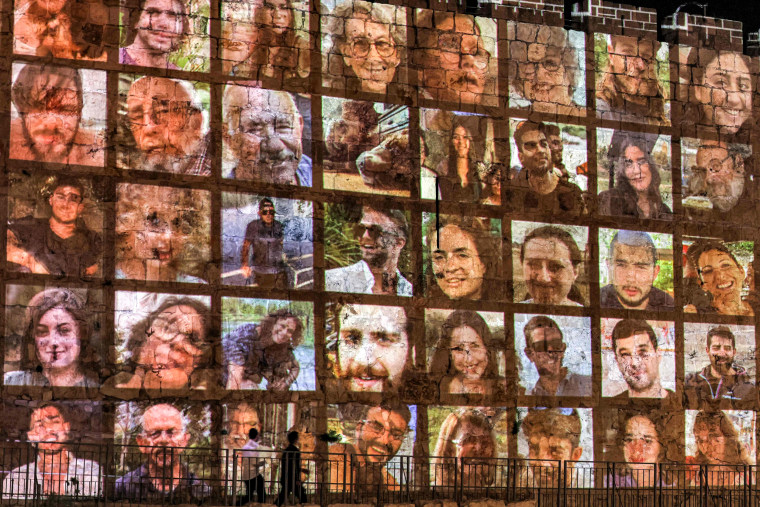 The faces of hostages currently held by Hamas are projected on the old city walls in Jerusalem.
