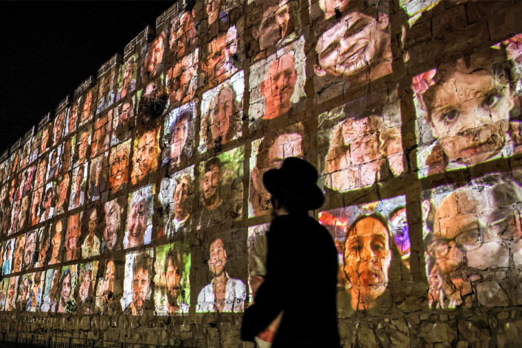 The faces of hostages currently held by Hamas are projected on the old city walls in Jerusalem.