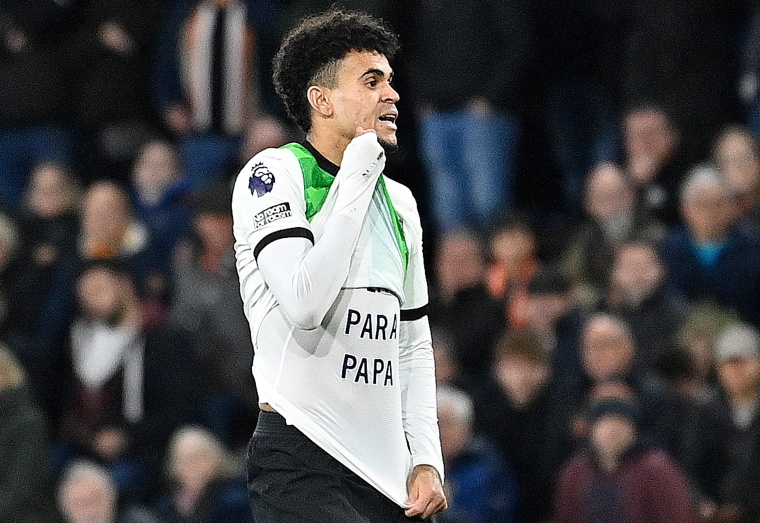 Liverpool's Colombian midfielder Luis Diaz flashes a message on his short after scoring against Luton Town in Luton, north of London, on Nov. 5, 2023. 