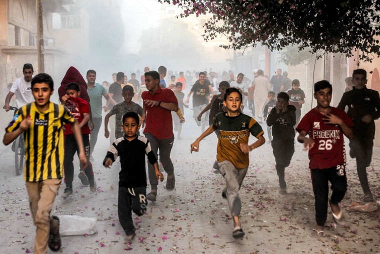 Palestinian children run as they flee from Israeli bombardment in Rafah in the southern Gaza Strip.