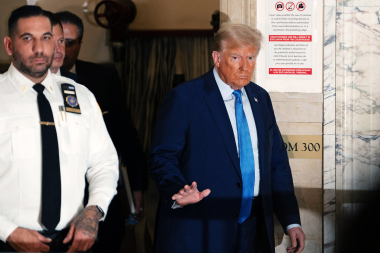 Former President Donald Trump returns from a break during his trial in New York State Supreme Court.