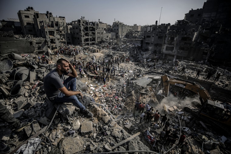 A man watches as Palestinians conduct a search and rescue operation after the second attack by the Israeli army at Jabalia refugee camp in Gaza City, Gaza on Nov. 1, 2023. 