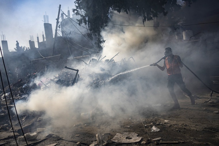 Firefighters extinguish a fire caused by an Israeli airstrike in Khan Younis refugee camp, southern Gaza Strip.