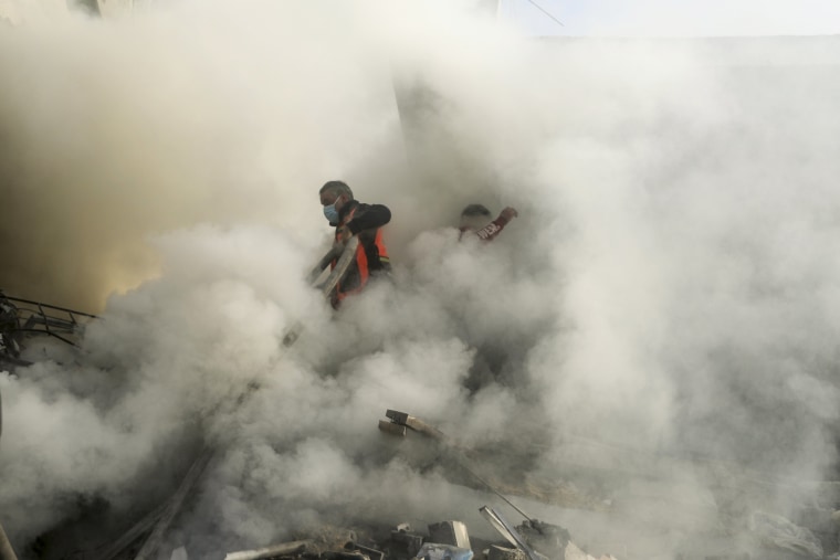Firefighters extinguish a fire caused by an Israeli airstrike in Khan Younis refugee camp, southern Gaza Strip.