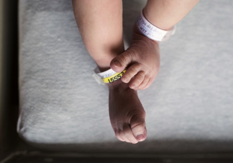 The feet and legs of a newborn baby born at a hospital